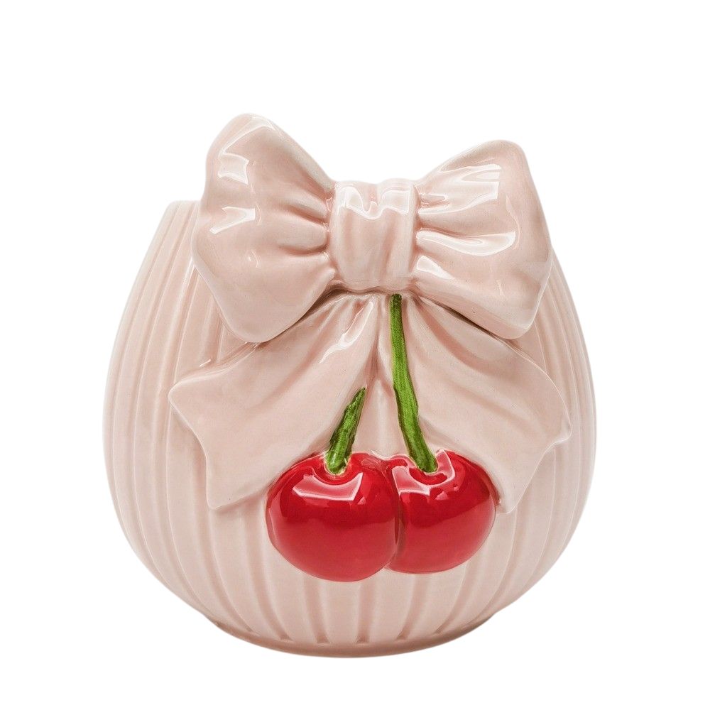 Ceramic pink planter with a bow and cherries on a white background