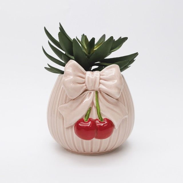 Ceramic planter with bow and cherries design on a white background