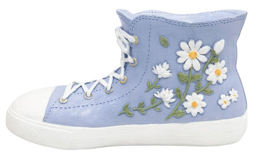 Blue high-top sneaker- shaped planter with floral embroidery on a white background