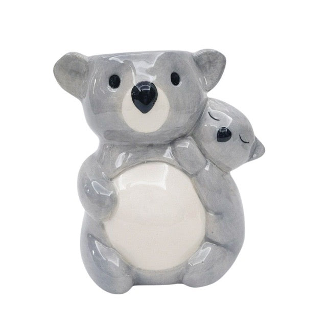 Ceramic koala plant pot holding a baby koala on a white background