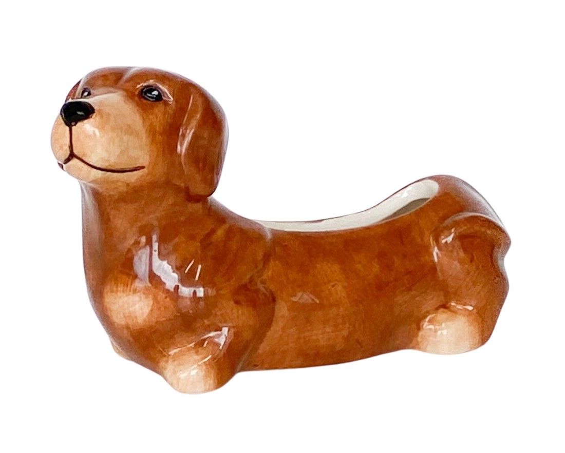 Brown ceramic dog-shaped plant pot on a white background