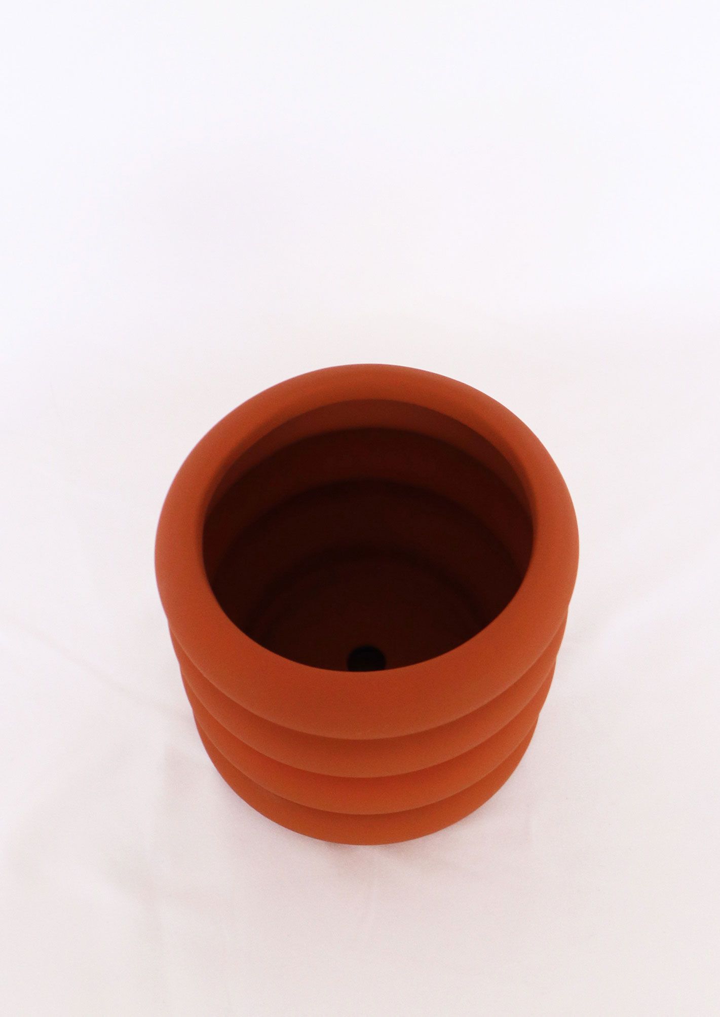 Naomi Ring Planter in orange with matching saucer – fun, sculptural indoor plant pot for stylish home gardens or gifts for plant lovers.
