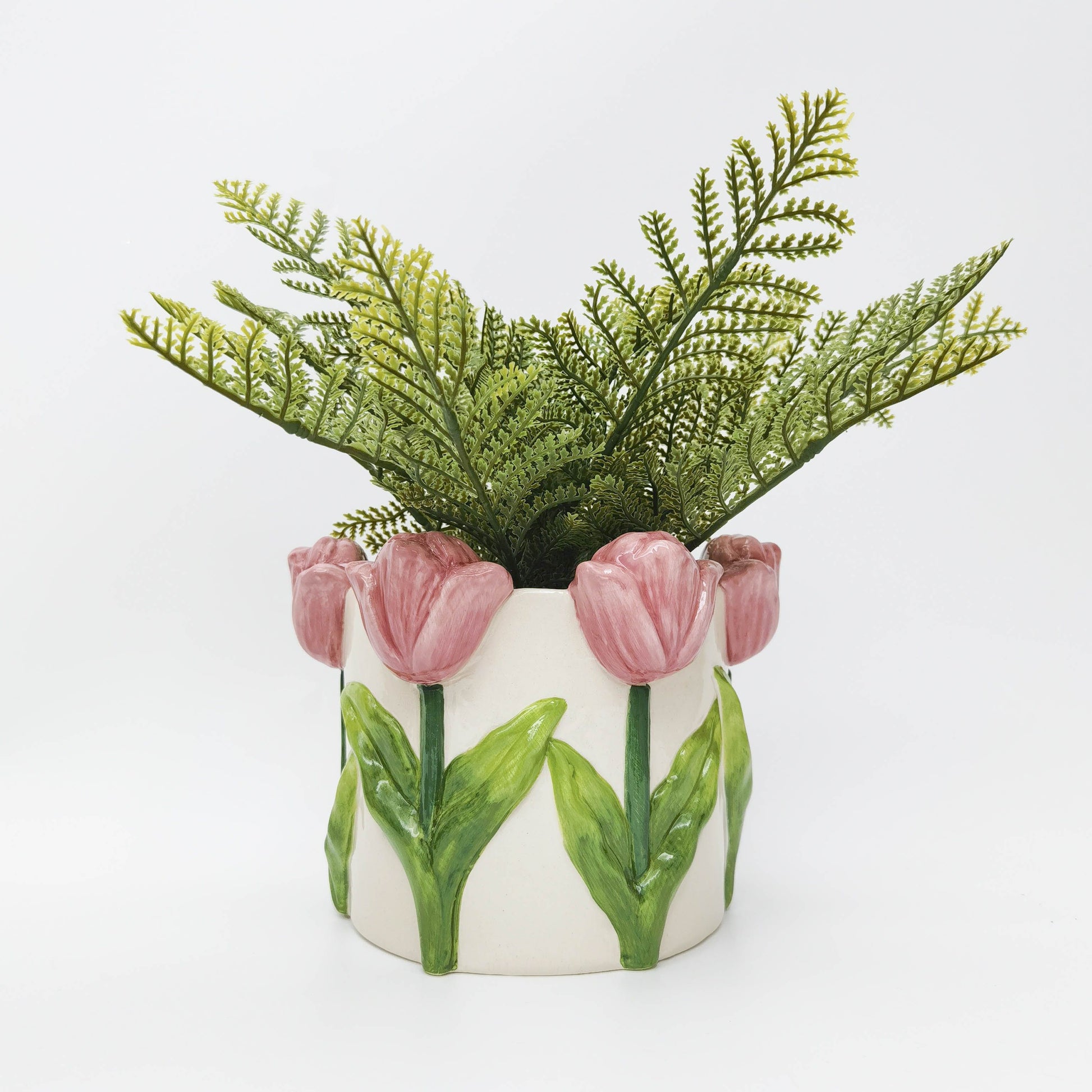 Ceramic planter with pink tulip design on a white background