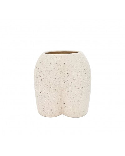 A beige ceramic vase with a playful, body-shaped design, resembling a bum, placed against a white tiled background.