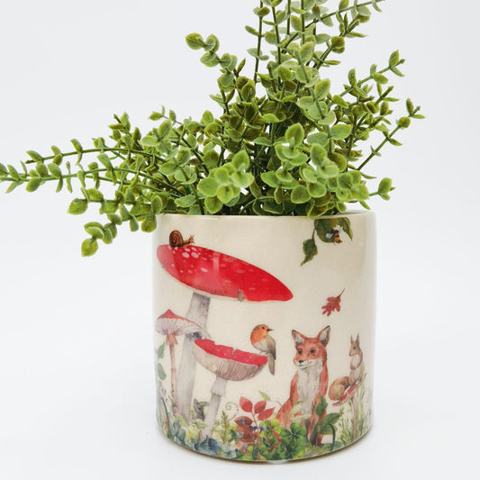 planter with whimsical design of animals and toadstools