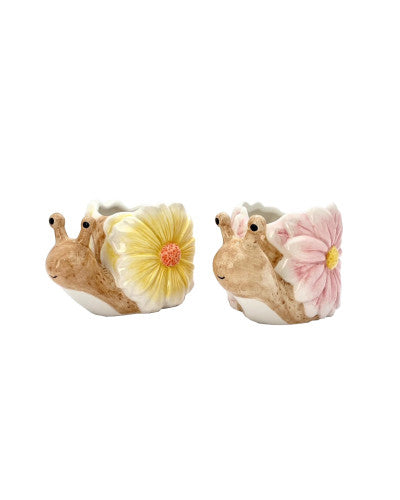 Two ceramic plant pots designed to look like snails, one with a yellow flower and the other with a pink flower