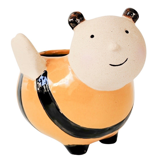 Ceramic planter designed to look like a bee with a face on a white background