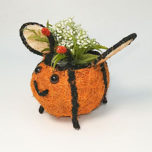 Decorative bee-shaped planter with flowers on a white background