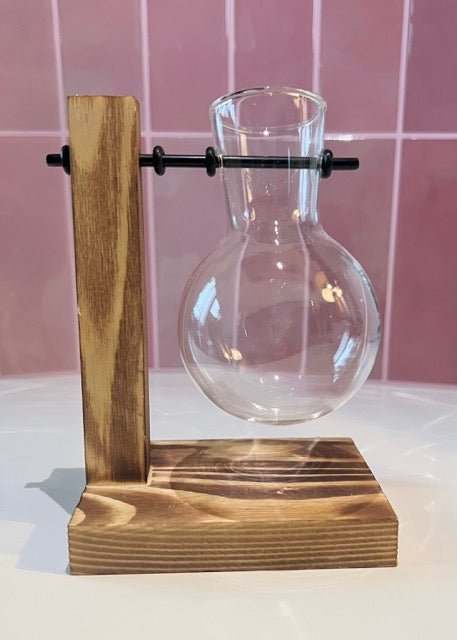 timber stand with black road and hanging glass jar for plant and flower cuttings