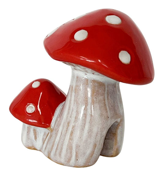 A ceramic pot hanger in the shape of two red and white toadstools with a textured beige stem.